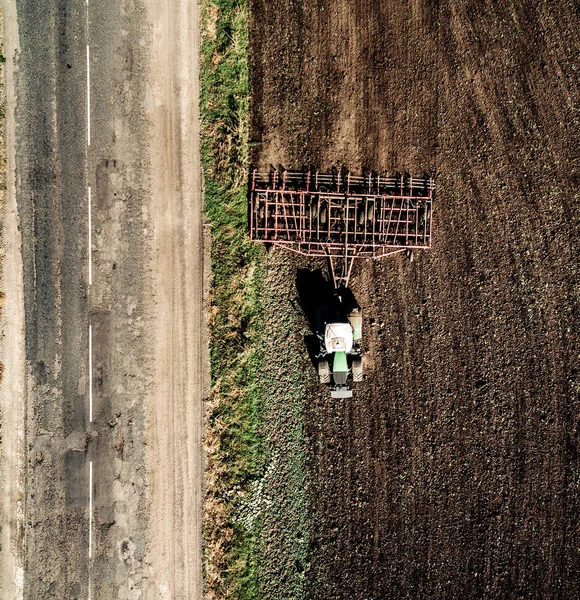 tractor plowing field, top view