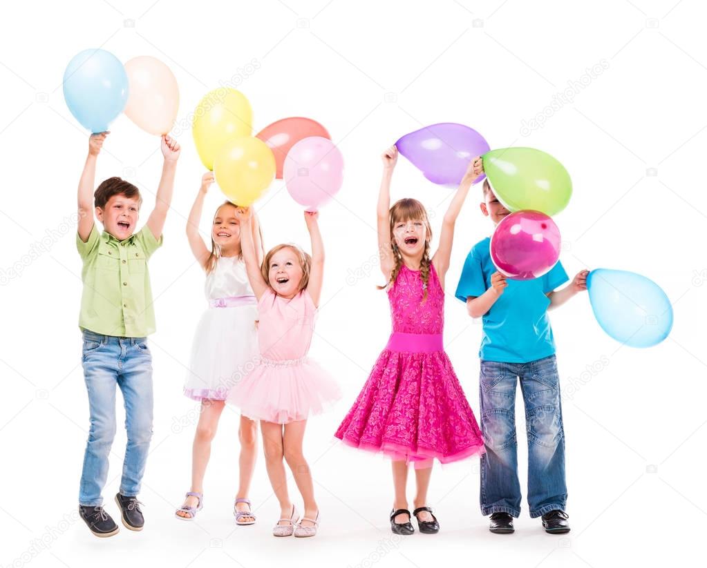cute little children with hands uo and baloons