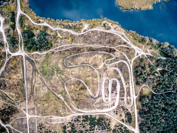 Top view of tracks in a suburb field with water on its side — Stock Photo, Image