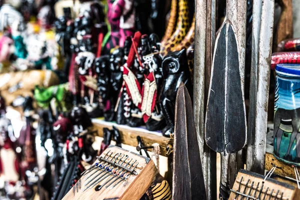 African spears and wooden figures at african souvenir market — Stock Photo, Image