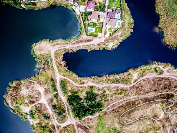 Connected pieces of land with rolled tracks and lakes on sides — Stock Photo, Image