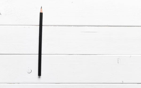 Black pencil on a table — Stock Photo, Image