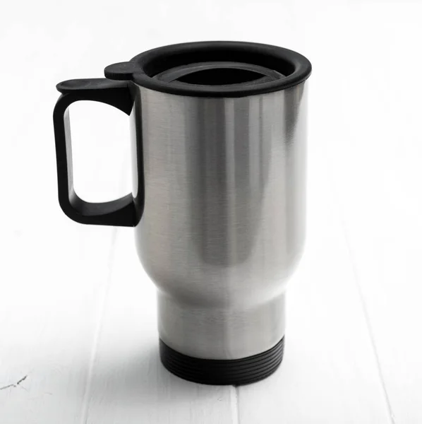 Huge thermocup with black comfortable handle — Stock Photo, Image