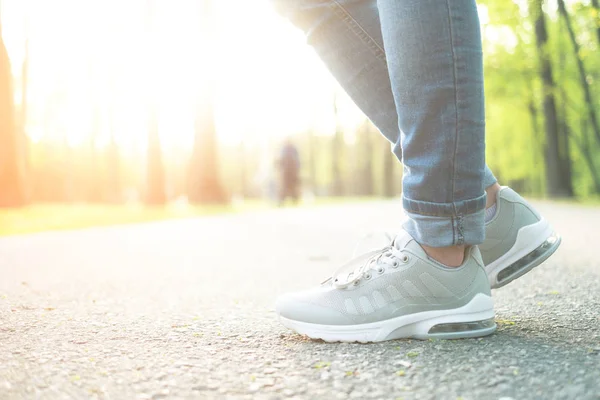 Person standing in gray sporty gumshoes