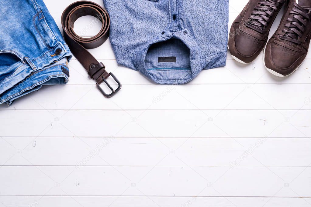 male clothes on wooden background with text space