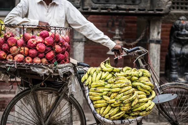 Man sells bananas and apples on a bike