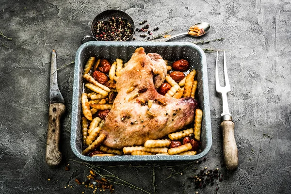 Fried turkey wing with fries in baking tray top view
