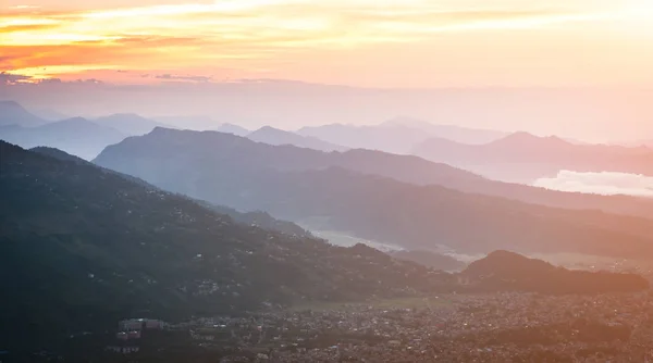 Закат над городом и горами Непала — стоковое фото