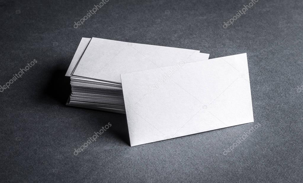 Blank white business card on grey background