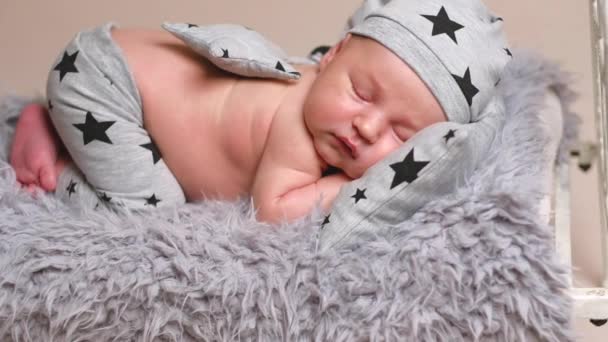 Newborn baby boy in grey pyjamas — Stock Video