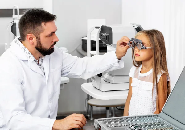 Doctor holding special eye equipment — Stock Photo, Image