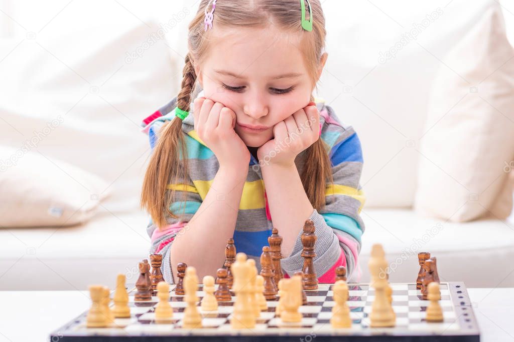 Child is in deep thought about chess winning strategy