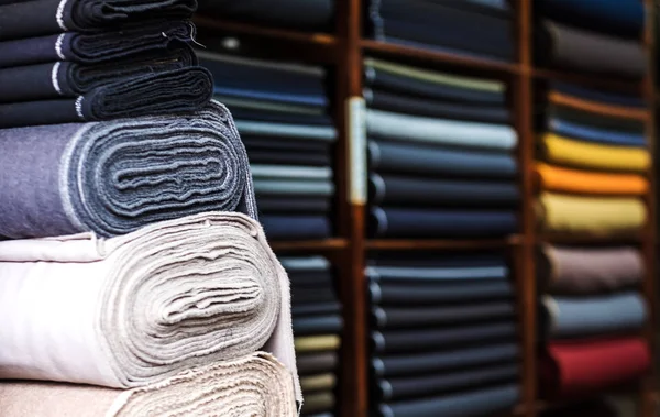 Rolls of fabric at the shelf — Stock Photo, Image