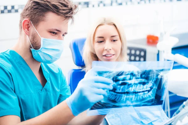Dentista mostrando paciente radiografia dentária — Fotografia de Stock