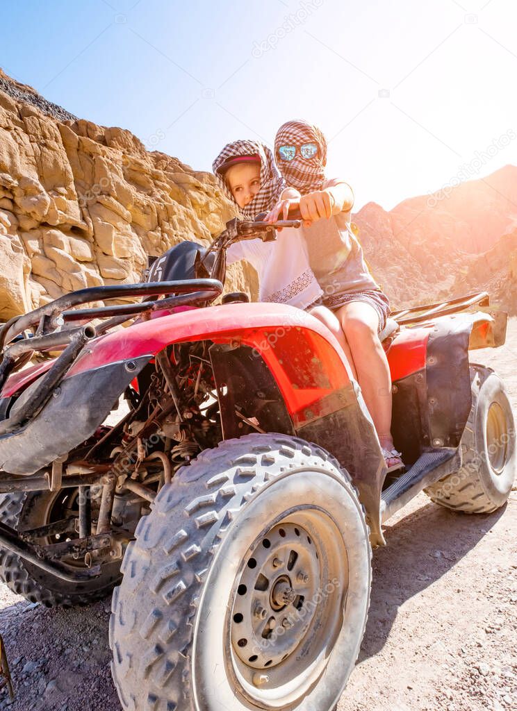 Excursion on quad bike with kid girl and her trainer
