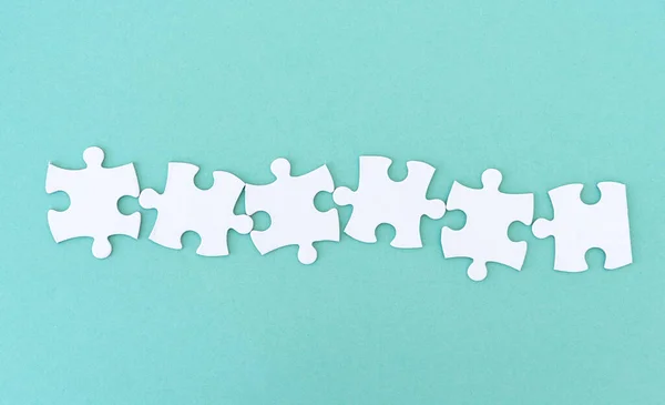 Jigsaw puzzle pieces in row — Stock Photo, Image