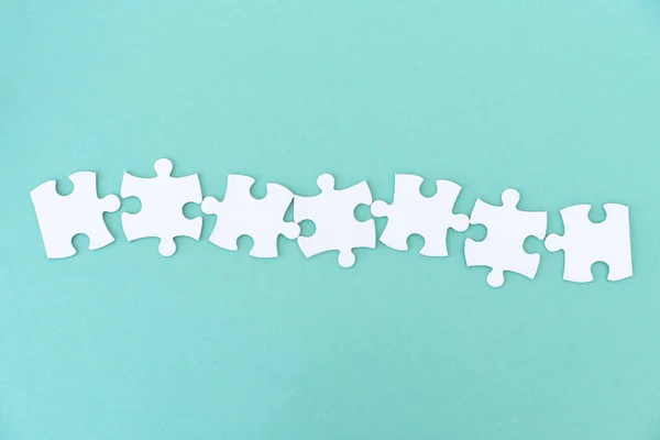 Jigsaw puzzle pieces in row — Stock Photo, Image