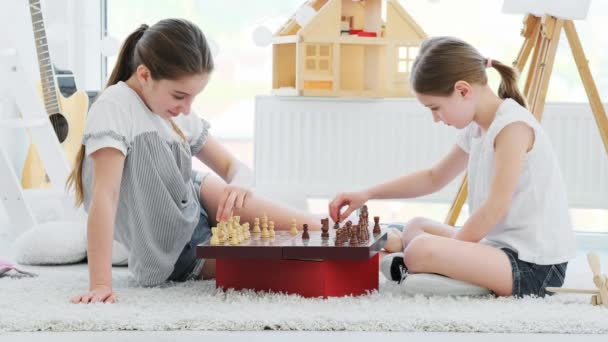 Cute girls kids playing chess game — Stock Video