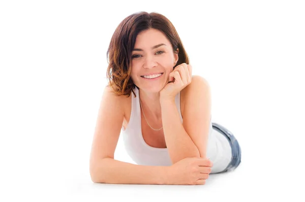 Beautiful young woman lying on a floor — Stock Photo, Image