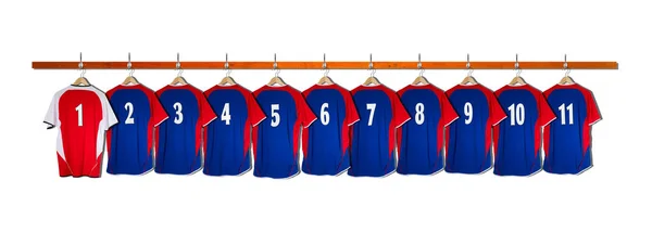 Rij van blauwe voetbalshirts met rode shirt 1-11 kleedkamer muur hangen — Stockfoto