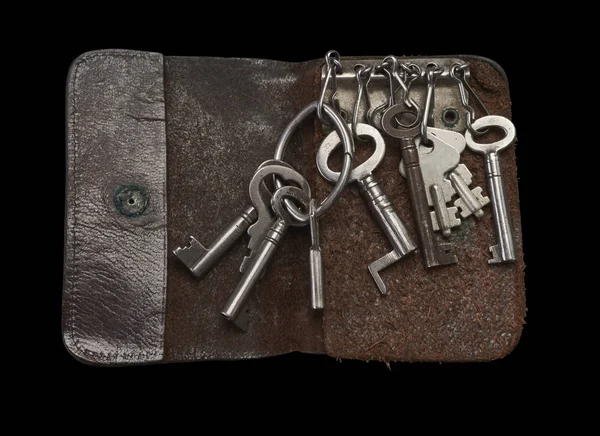 Old keys in key in leather key wallet on Black background — Stock Photo, Image