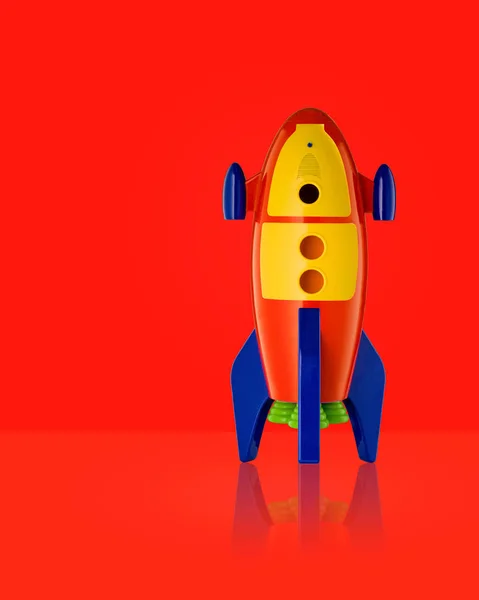 Niño juguete cohete sobre fondo rojo —  Fotos de Stock