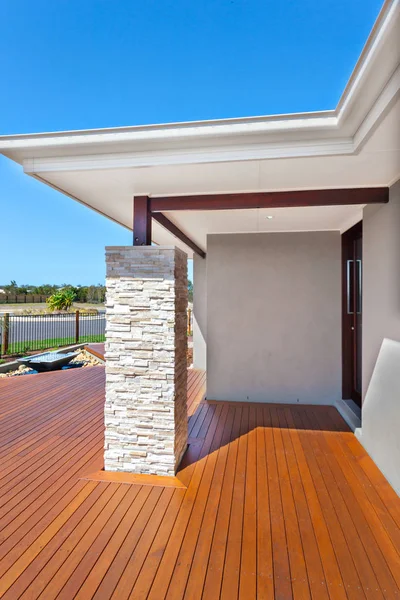 Entrada moderna da casa do lado com piso de madeira e um ston — Fotografia de Stock