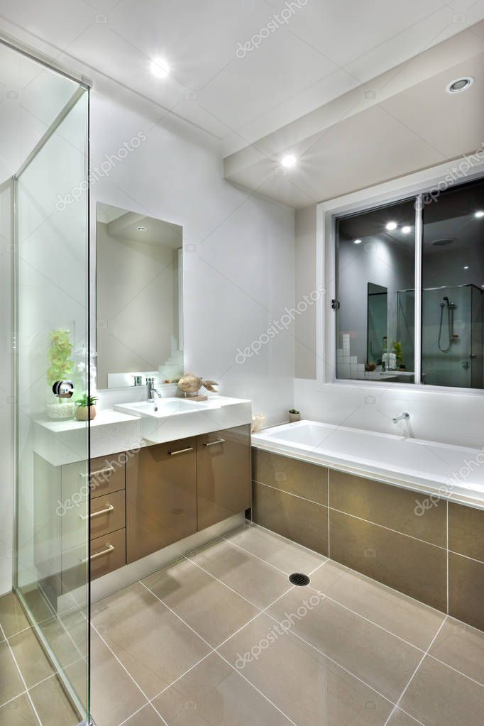 Modern Bathroom With Dark Color Floor Tiles With Lights On