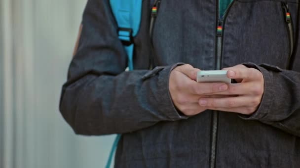 Tipo de manos masculinas en el teléfono al aire libre en el día frío — Vídeo de stock