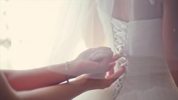 Bridesmaids Helping to Tie Her Wedding dress — Stock Video