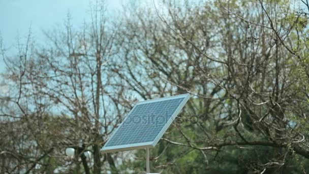 Panneau solaire dans la ville sur le ciel bleu et l'arbre — Video