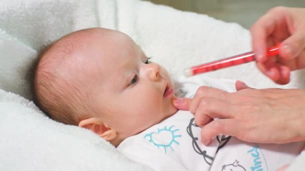 Baby Girl is Taking Medicine by a syringe — Stock Video