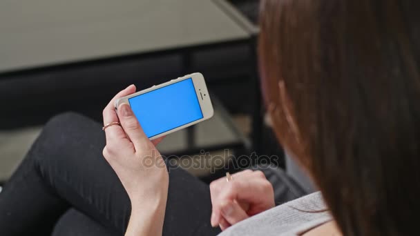 Femme tient Smartphone avec écran bleu 