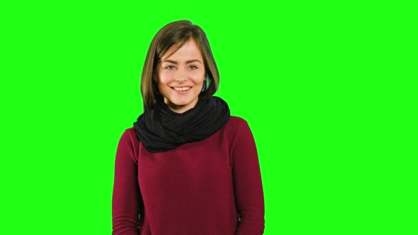 A Friendly Lady Smiling against a Green Background — Stok Video