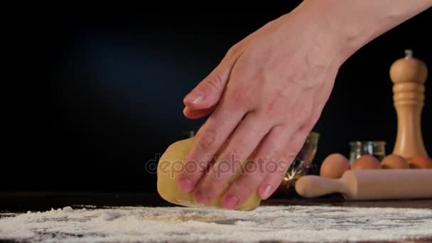 Женские руки разминают тесто на столе — стоковое видео