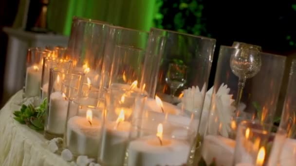 Many Burning Candles in Transparent Glasses — Stock Video