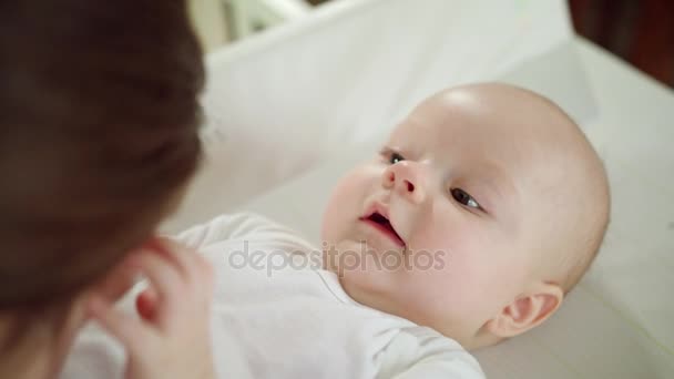 Babys acostado en la cama y jugando con su madre — Vídeo de stock