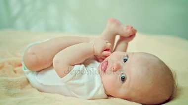 Eve yemek kendi ayakları, yatakta bebek Lying