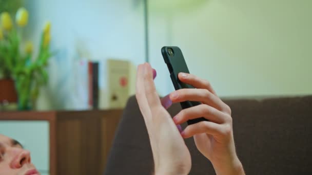 Man Laying on the Sofa and Using Mobile Phone — Stock Video