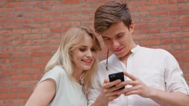 Genç bir çift bir cep telefonu açık havada kullanma