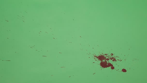 Éclaboussure d'encre rouge sur fond d'écran vert 