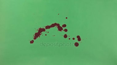 Kırmızı mürekkep sıçramak yeşil ekran arka planı üzerinde
