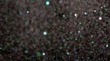Siyah arka plan üzerinde patlayan gerçekçi Glitter.