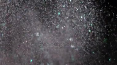 Siyah arka plan üzerinde patlayan gerçekçi Glitter.