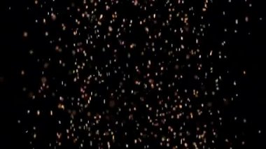 Siyah arka plan üzerinde patlayan gerçekçi Glitter.