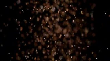 Siyah arka plan üzerinde patlayan gerçekçi Glitter.