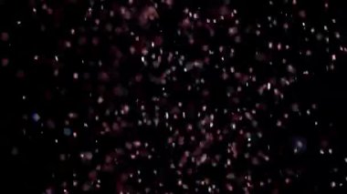 Siyah arka plan üzerinde patlayan gerçekçi Glitter.