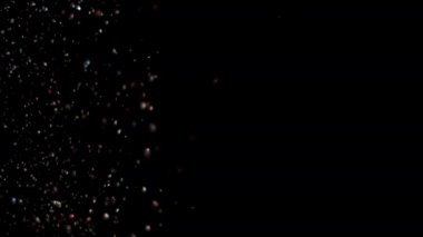 Siyah arka plan üzerinde patlayan gerçekçi Glitter.