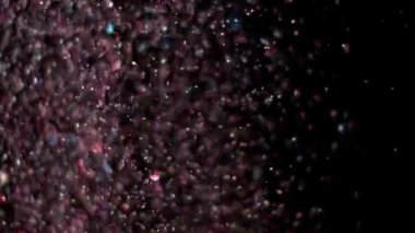 Siyah arka plan üzerinde patlayan gerçekçi Glitter.