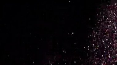 Siyah arka plan üzerinde patlayan gerçekçi Glitter.